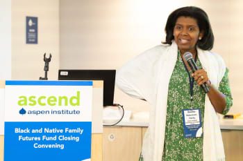 Aspen Institute Community Strategies Group Co-Executive Director Bonita Robertson-Hardy speaks into a microphone at the Black and Native Family Futures Fund Closing Convening